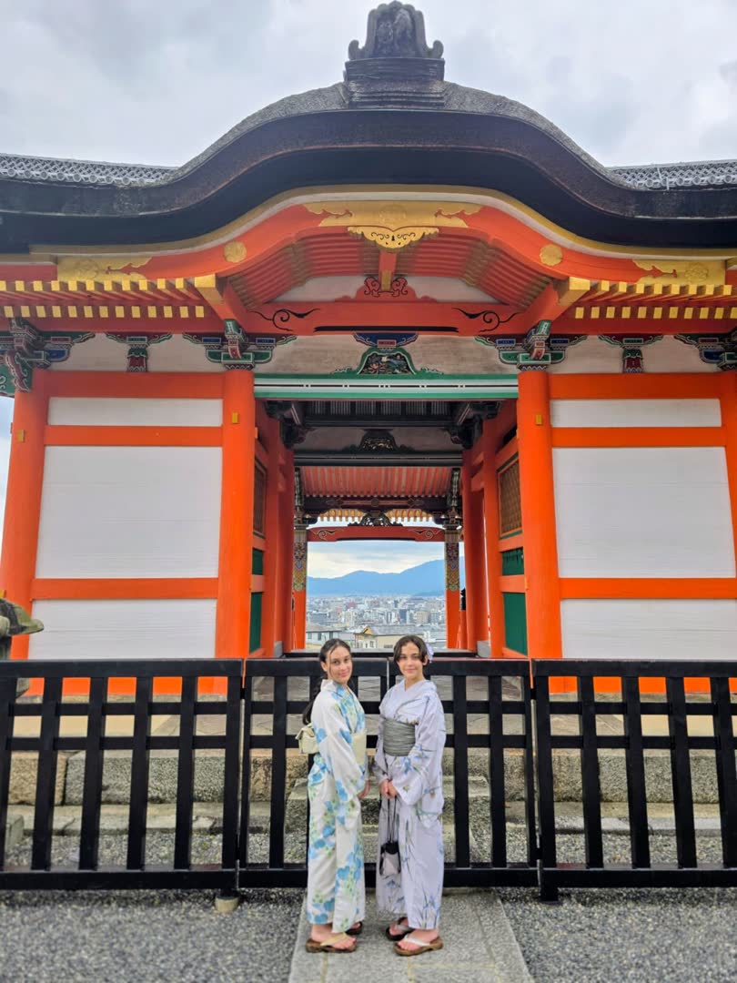Jovens vestindo quimono diante de um portão tradicional em Kyoto